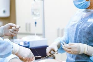 An image of surgeons preparing to carry out a penile girth enhancement surgery on a man.