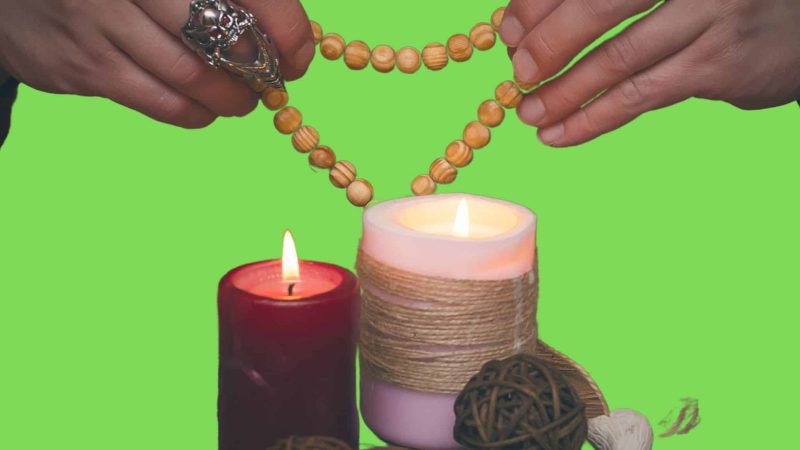 A picture of a healer's hands and divination materials on display.