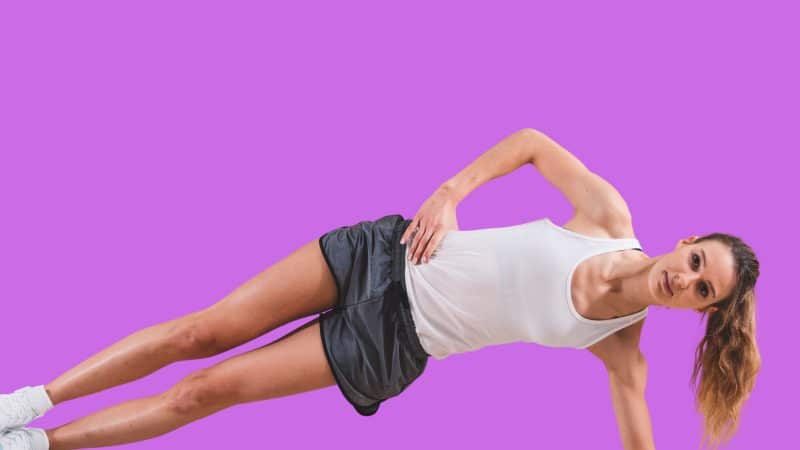 An image of a woman carrying out flexibility exercises that stretch the hip joint as one of the techniques for getting wider hips.