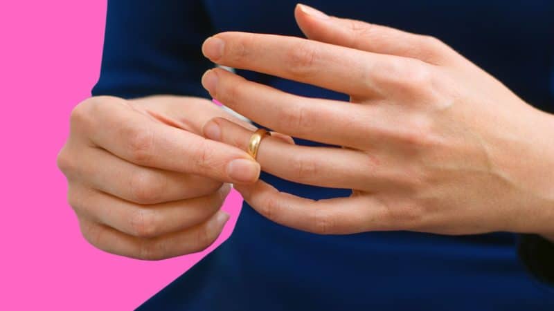 An image of a woman removing her marriage ring after using the divorce spell.