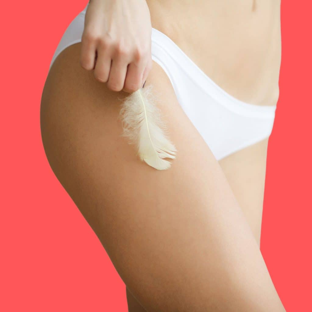 A photo of a woman applying the hips enlargement cream onto her thighs