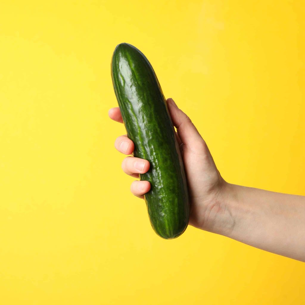 A picture of a hand holding a cucumber illustrates the different sizes a dick goes through during the use of penis enlargement oil