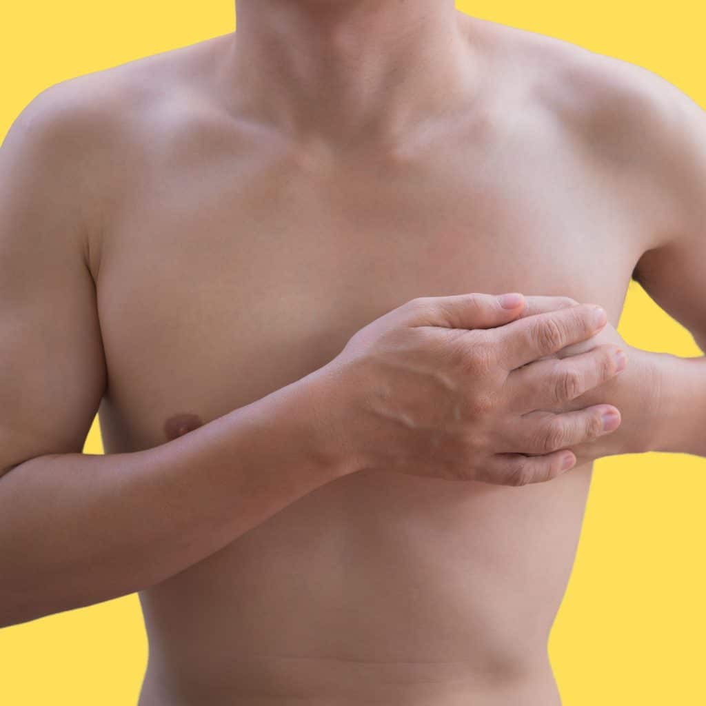 An image of a man with a bare chest preparing to apply the creams that grow breasts for males